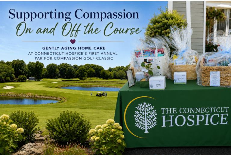 Outdoor charity golf event with a large banner that says 'Supporting Compassion On and Off the Course' beside gift baskets for The Connecticut Hospice on a sunny course backdrop.